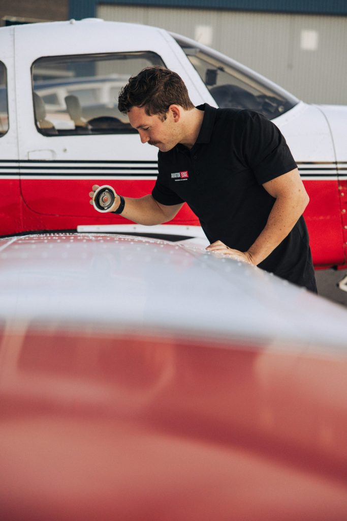 Mechanic inspecting a small airplane wing