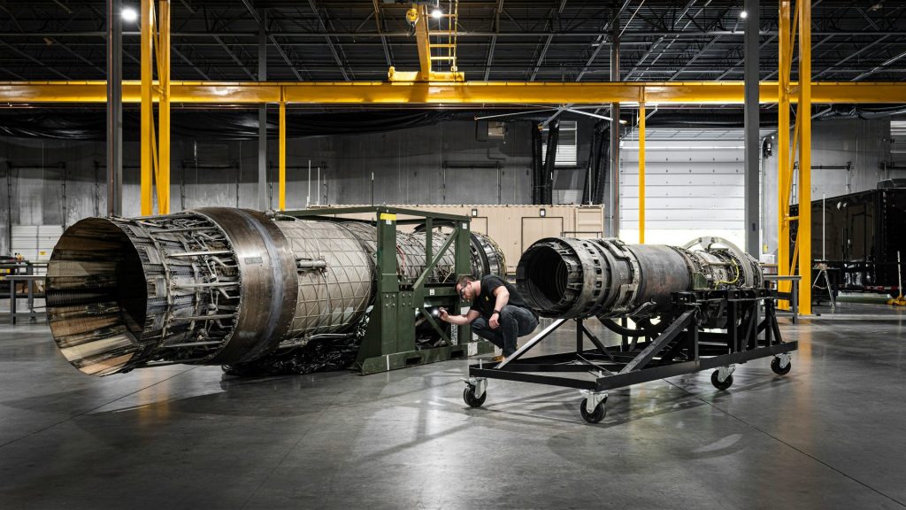 a man working on a large machine in a factory